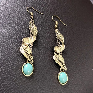 Gold drop earrings with turquoise stones and leaf details