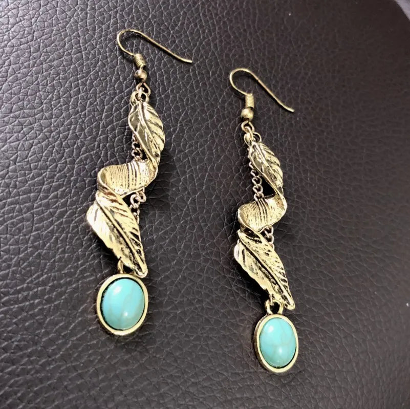 Gold drop earrings with turquoise stones and leaf details