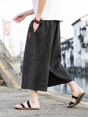 Gray relaxed fit wide-leg casual pants with drawstring and embroidered detail.