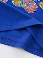 Blue cotton blend toddler t-shirt with vibrant embroidered fish graphic and crew neck.