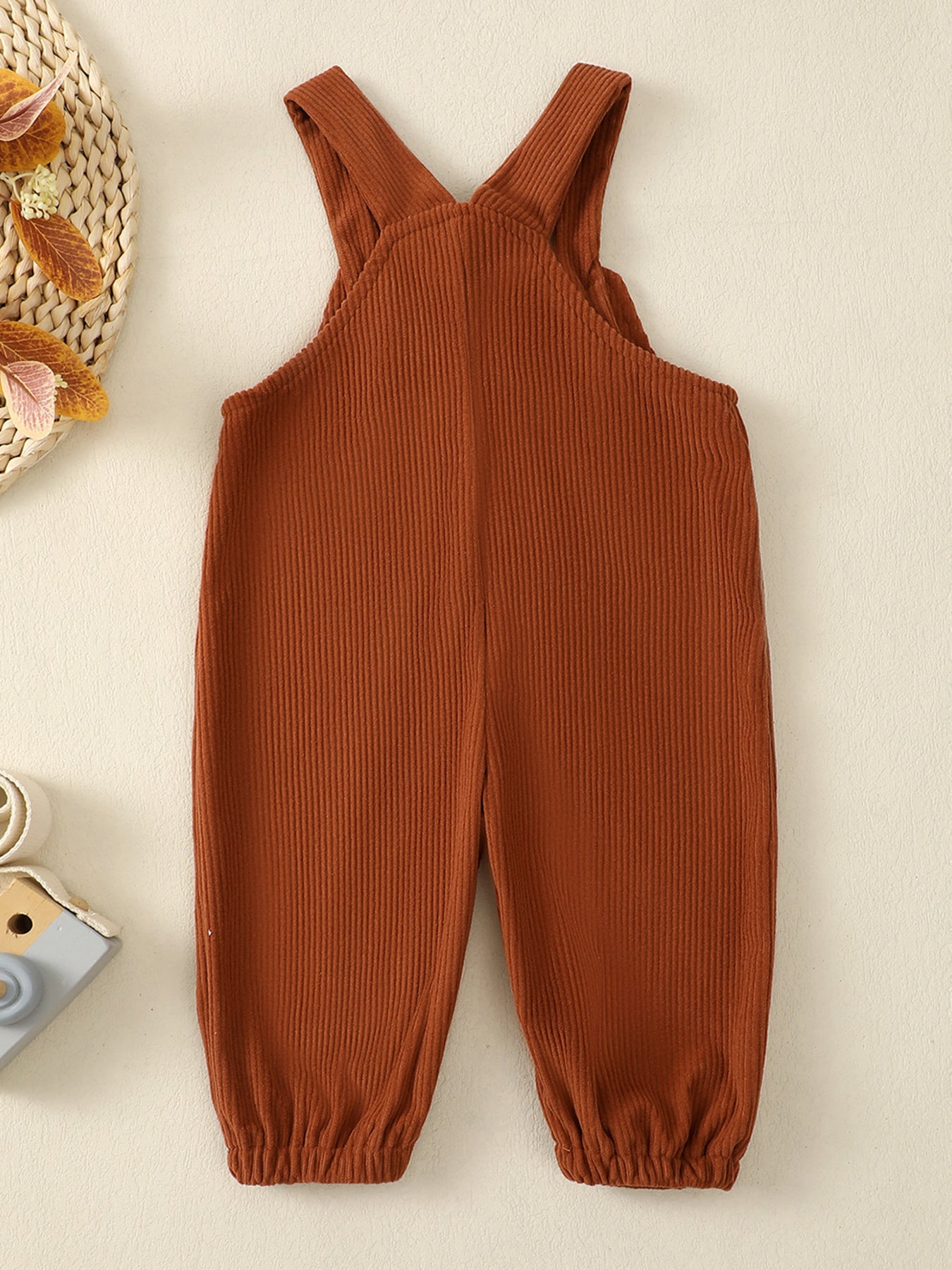Kids brown corduroy overalls with adjustable straps and elastic cuffs