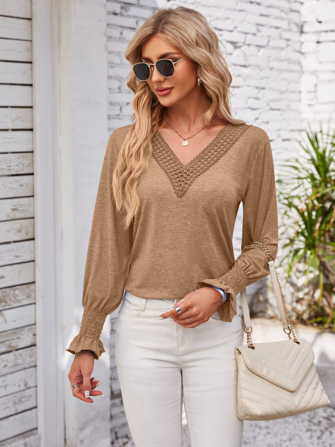 Camel V-neck blouse with lace trim and blouson sleeves.