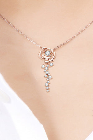 Rose gold necklace with rose pendant and cubic zirconia cascade detail.
