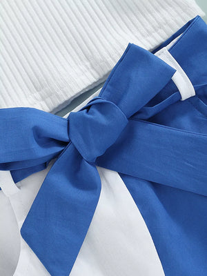 Blue and white two-piece baby outfit with ribbed knit top and bow detail skirt.