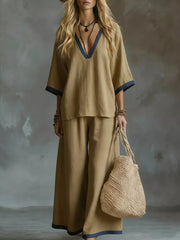 Camel V-neck two-piece set with contrast trim and wide leg pants.