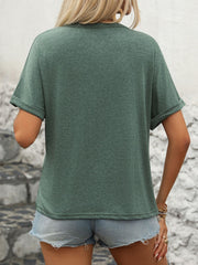 Green Henley pocket tee with rolled sleeves and a casual fit.