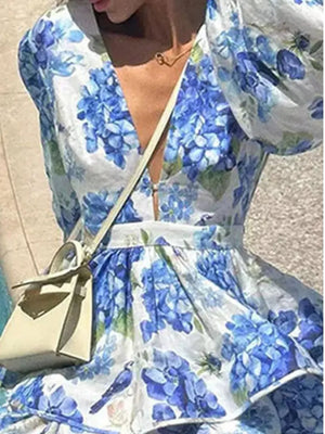 Blooming Ruffle Layered Mini Dress in Sky Blue with floral print and puff sleeves.