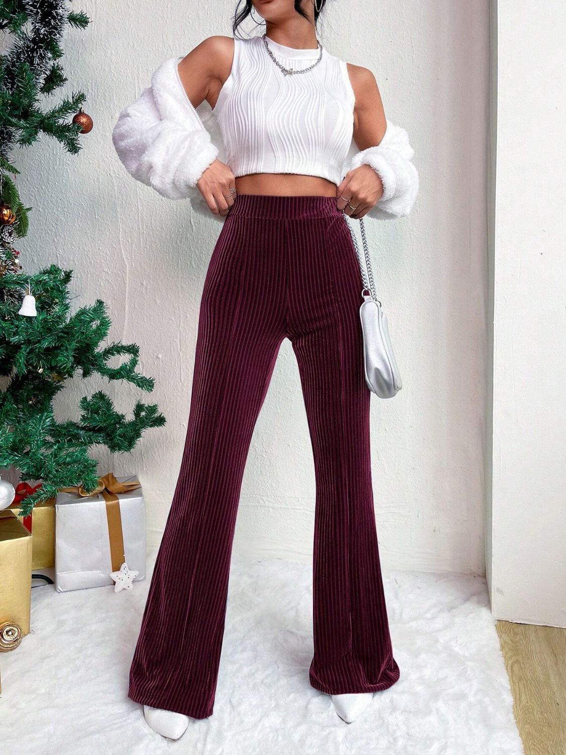 Burgundy corduroy bell bottom trousers with vertical texture.