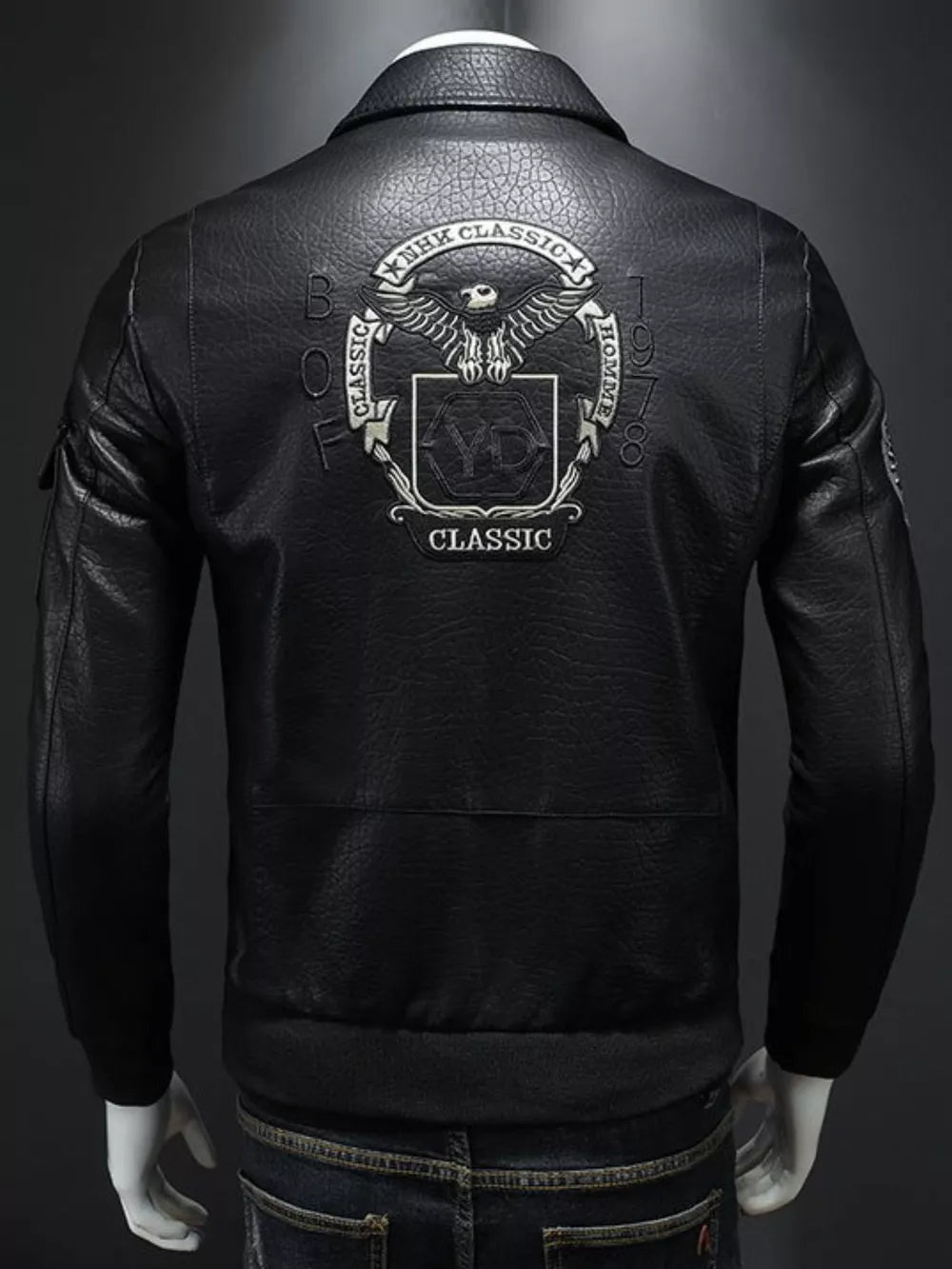 Black leather bomber jacket with embroidered eagle crest and "Classic" text on the back.