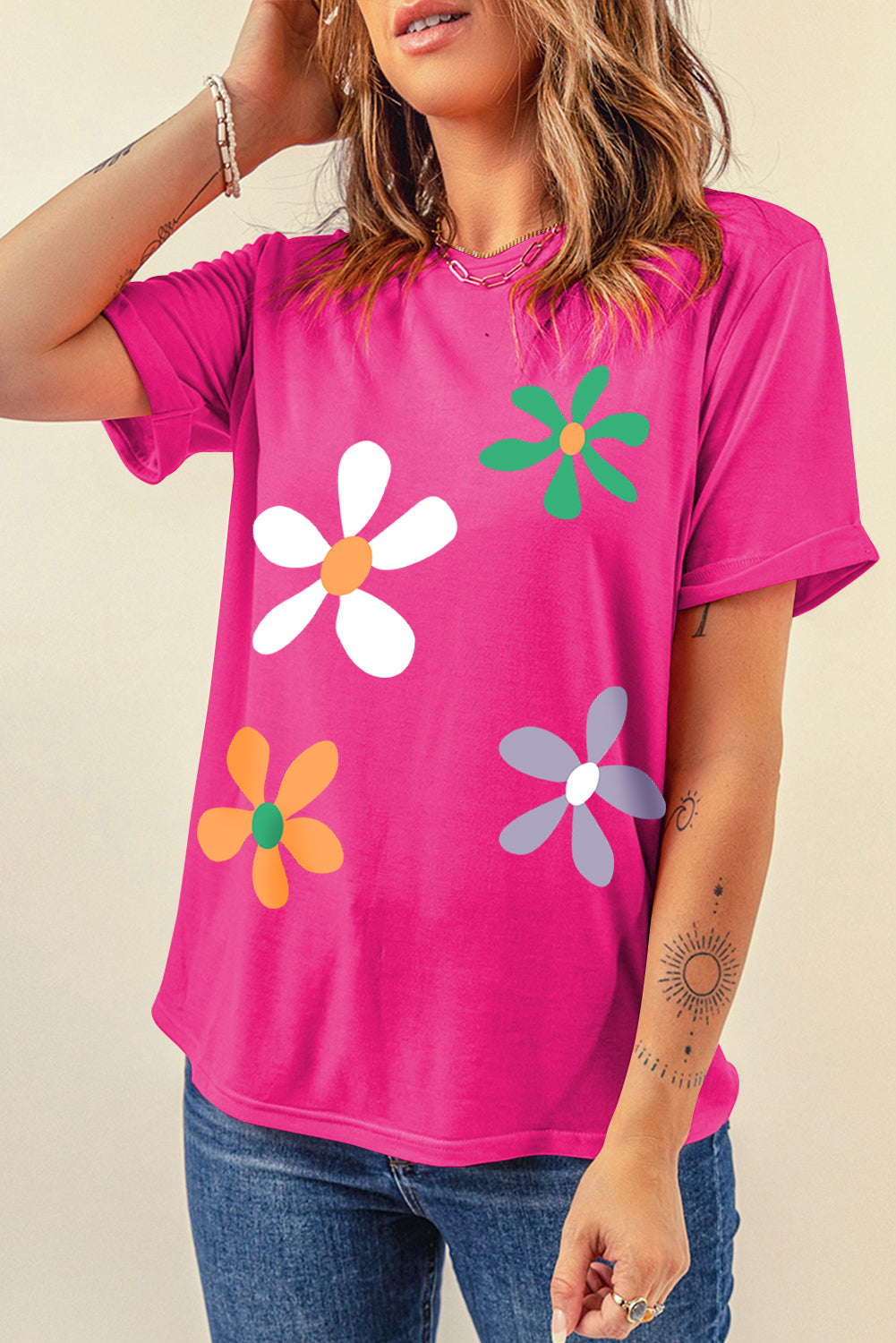 Hot pink t-shirt with a retro daisy graphic in white, green, orange, and purple.
