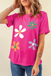 Hot pink t-shirt with a retro daisy graphic in white, green, orange, and purple.