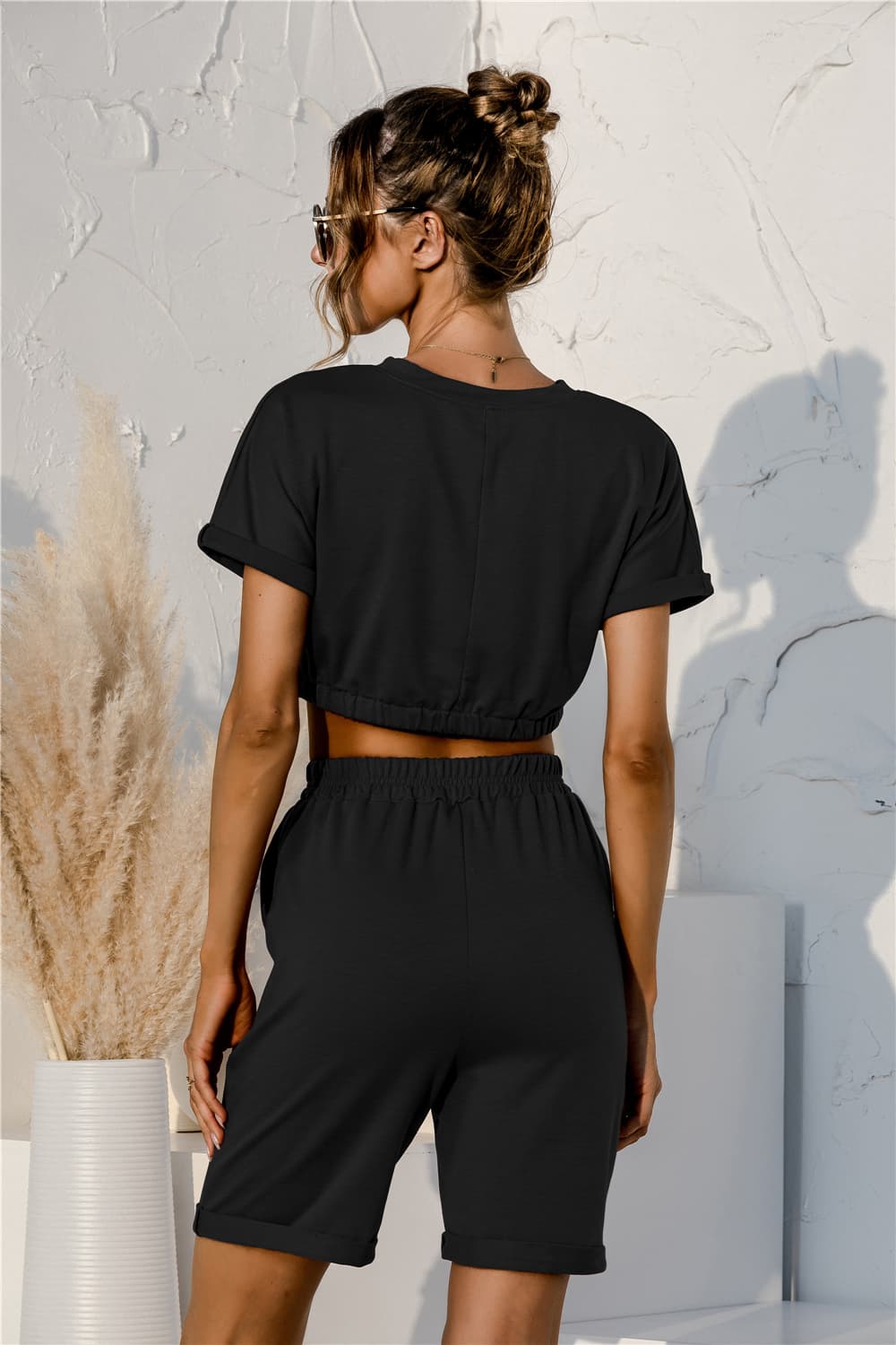 Black lounge set with rolled sleeve crop top and drawstring shorts