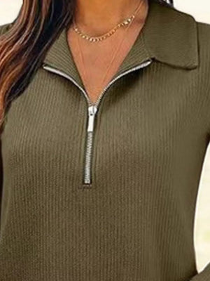 Ribbed knit half-zip top in army green with a collared neckline and silver zipper detail.