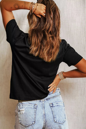 Black cotton t-shirt with relaxed fit and short sleeves, styled with denim shorts.