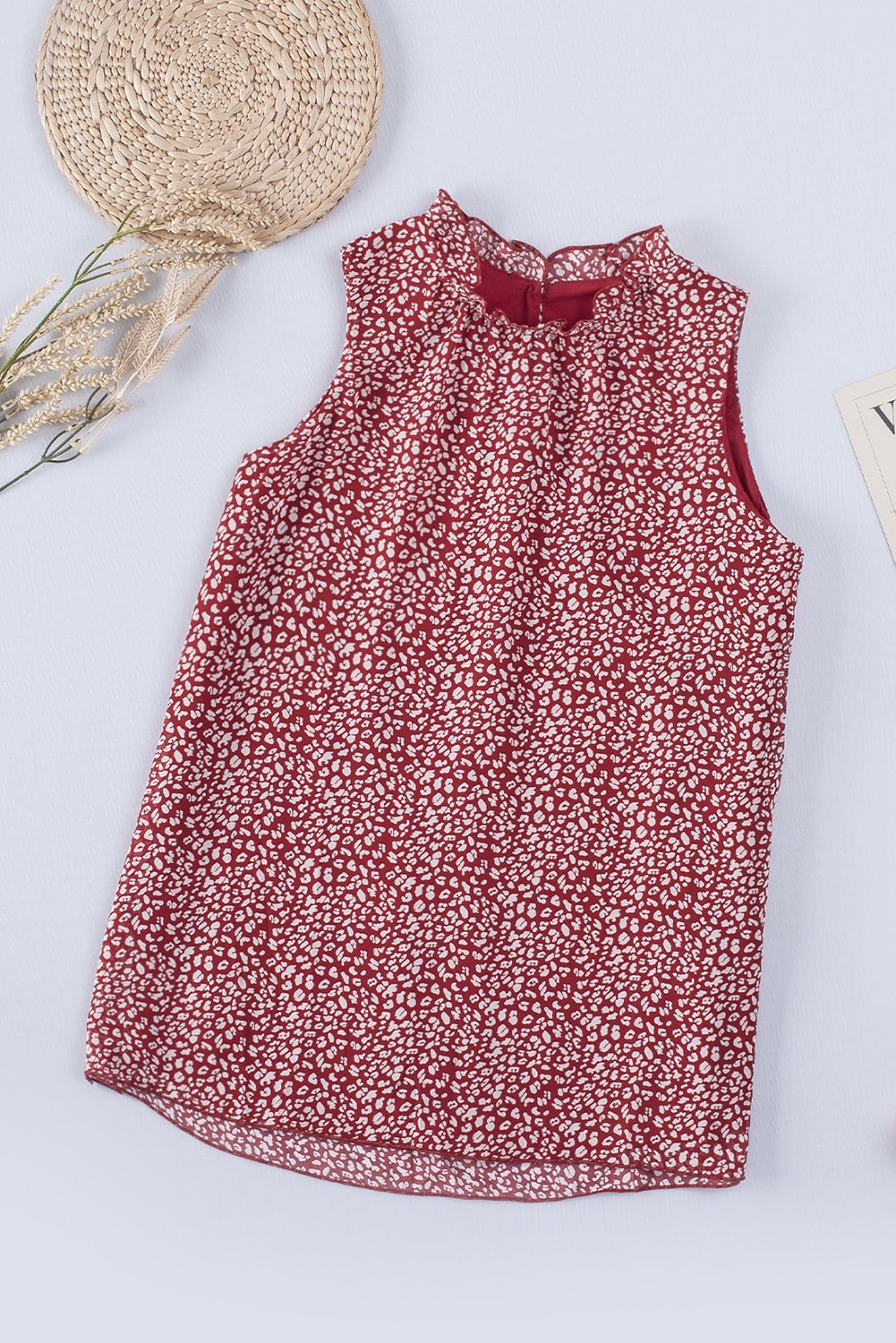 Burgundy printed sleeveless blouse with ruffled neckline