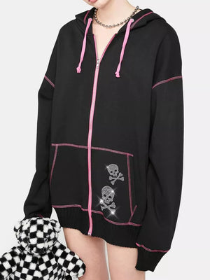 Black zip-up hoodie with pink contrast stitching, drawstring hood, and rhinestone skull graphics.