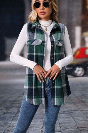 Plaid utility vest in dark green with button front and patch pockets, worn over a white turtleneck and jeans.