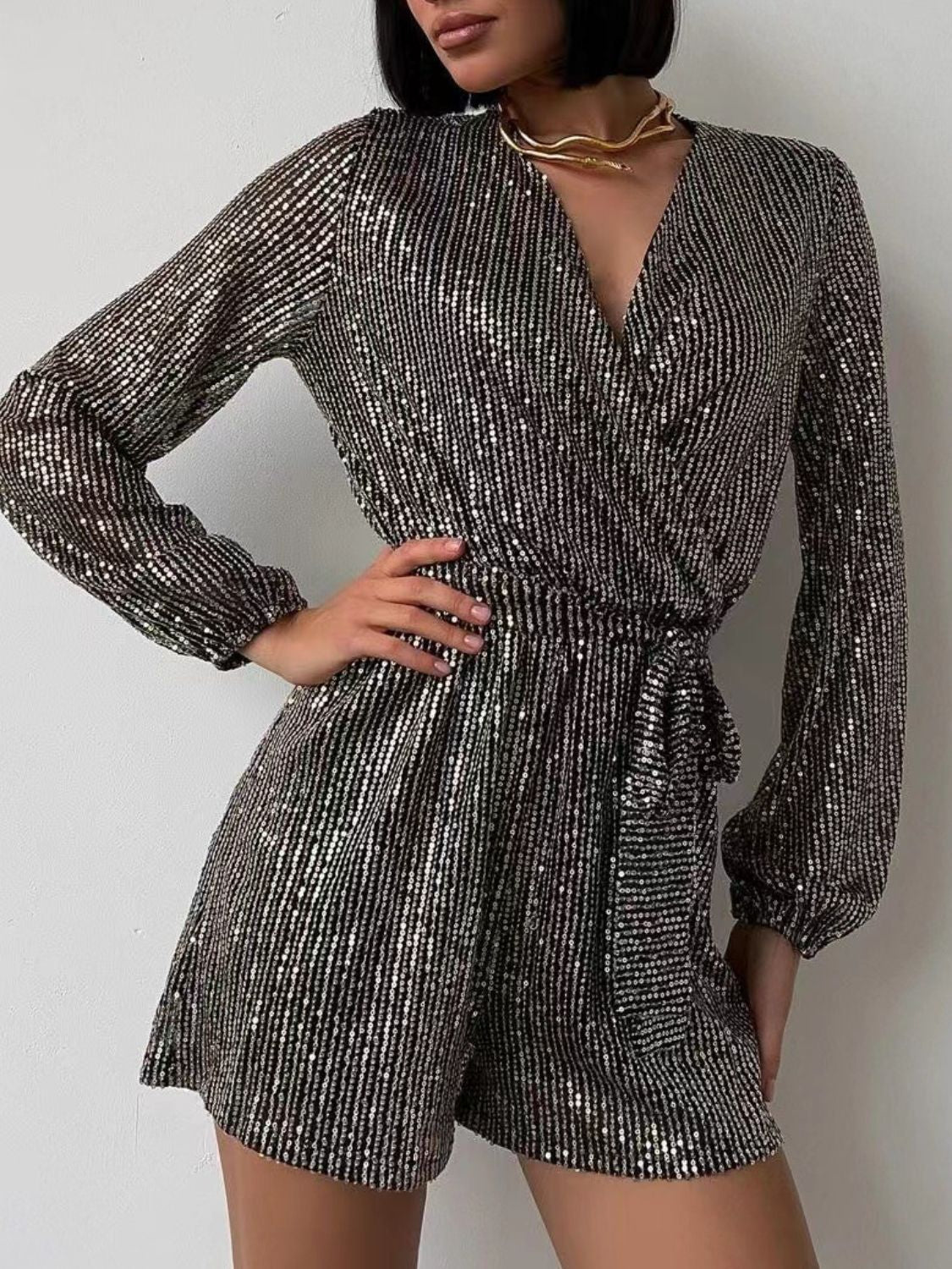 Sequin wrap romper in black/silver with blouson sleeves and tie waist.