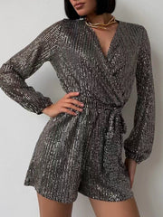 Sequin wrap romper in black/silver with blouson sleeves and tie waist.