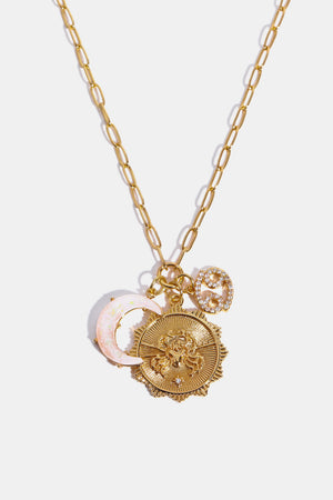 Gold pendant necklace with Cancer zodiac, moon, and star charms.