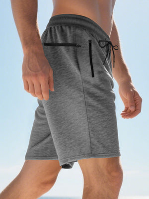 Dark gray chino shorts with drawstring waist and zippered pockets.