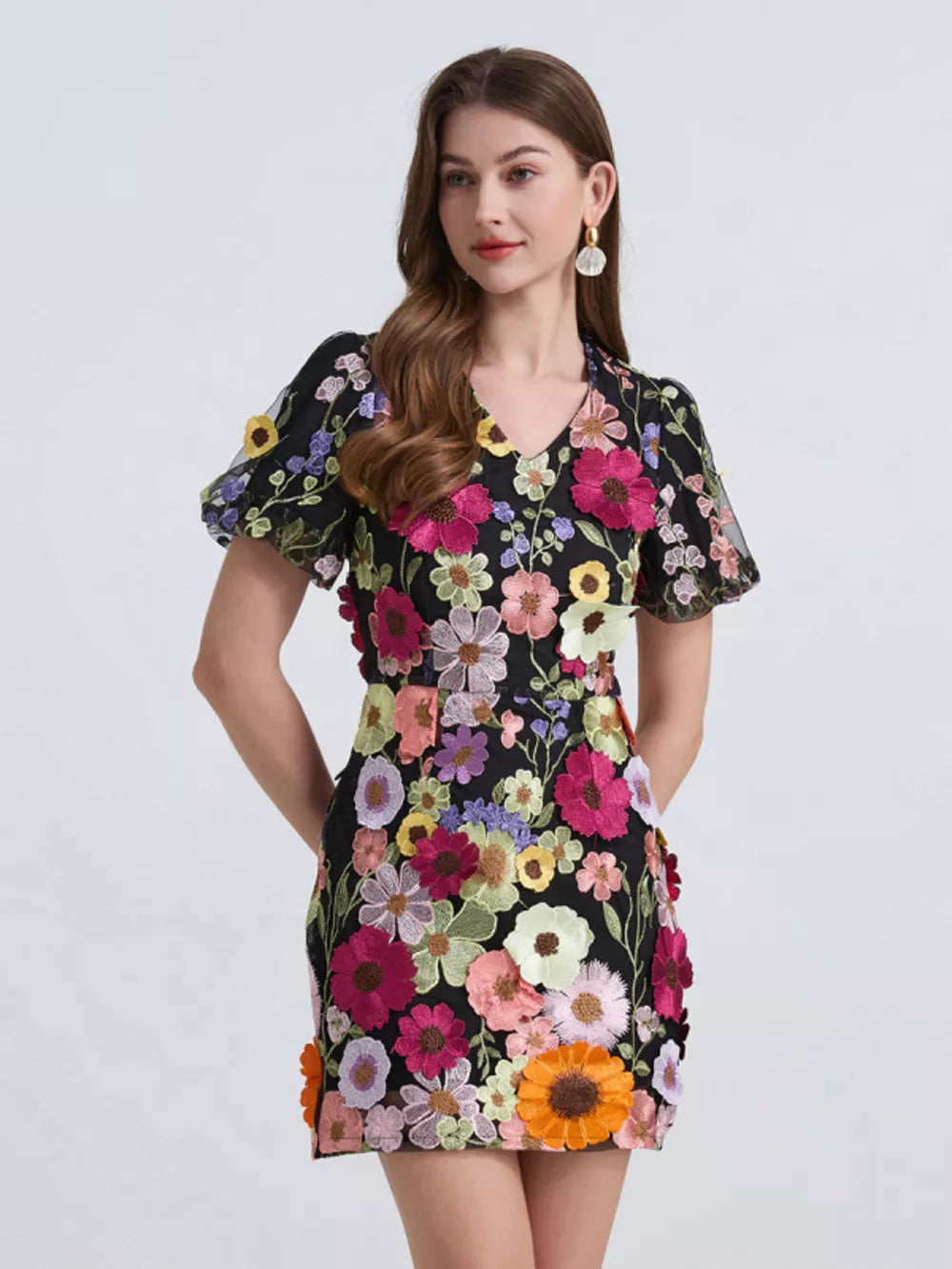 Black floral mini dress with puff sleeves and colorful applique flowers.