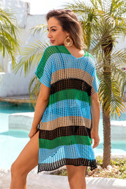 Rainbow crochet beach cover-up with short sleeves and side slits, featuring horizontal stripes in green, blue, tan, and