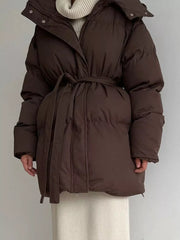 Dark brown belted puffer trench coat with hood and a tie waist.