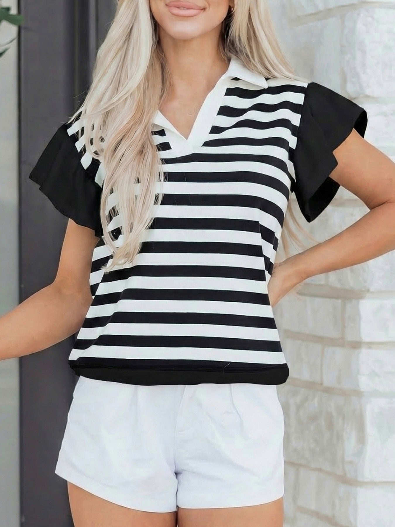 Black and white striped cotton blouse with ruffled black sleeves and a collared v-neck.