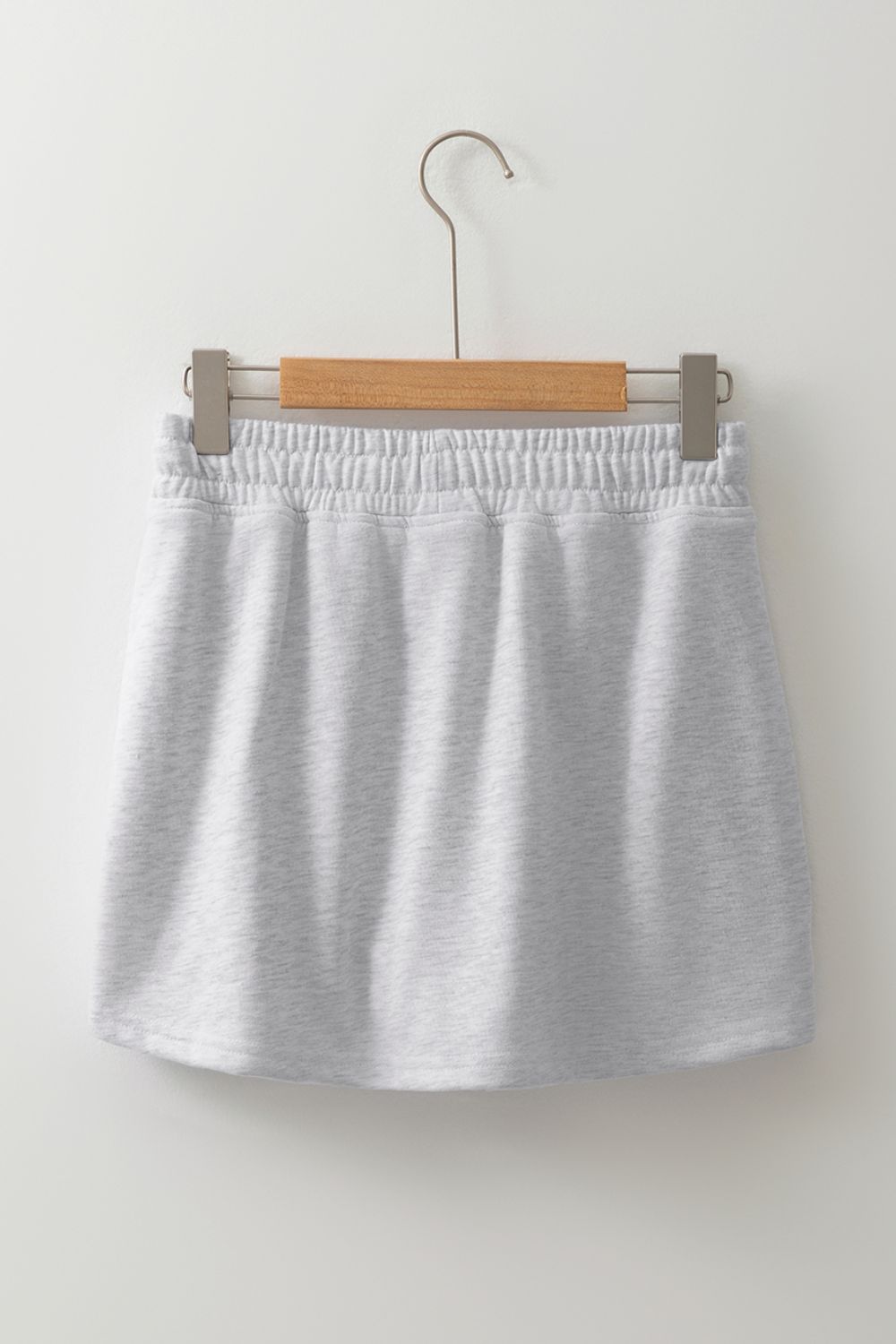 Light gray French terry drawstring skort with pockets and elastic waistband.