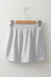 Light gray French terry drawstring skort with pockets and elastic waistband.
