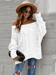 White cable knit off-shoulder sweater with open knit details and slouchy fit.