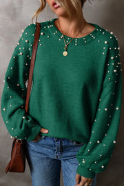 Dark green knit sweater with pearl embellishments on sleeves and neckline.
