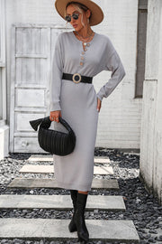 Light gray textured knit henley midi dress with button detail and long sleeves.