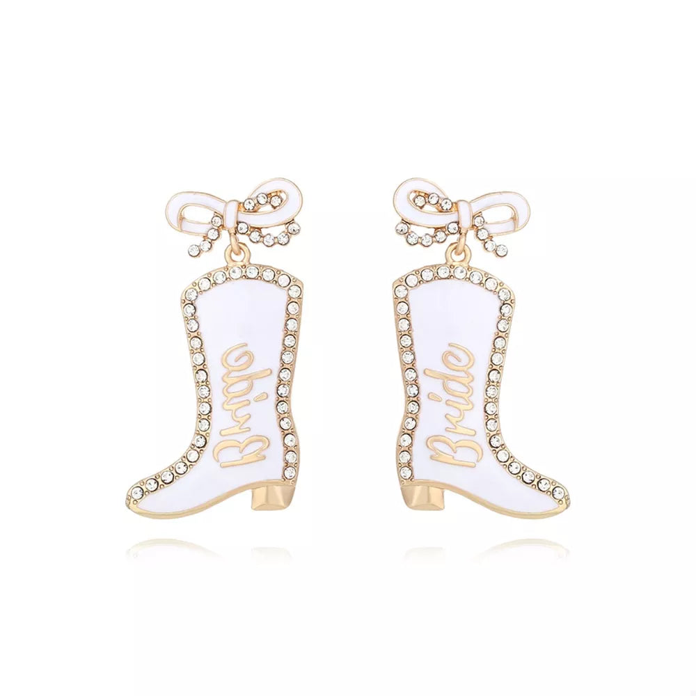 White bridal cowboy boot dangle earrings with gold trim and rhinestones.