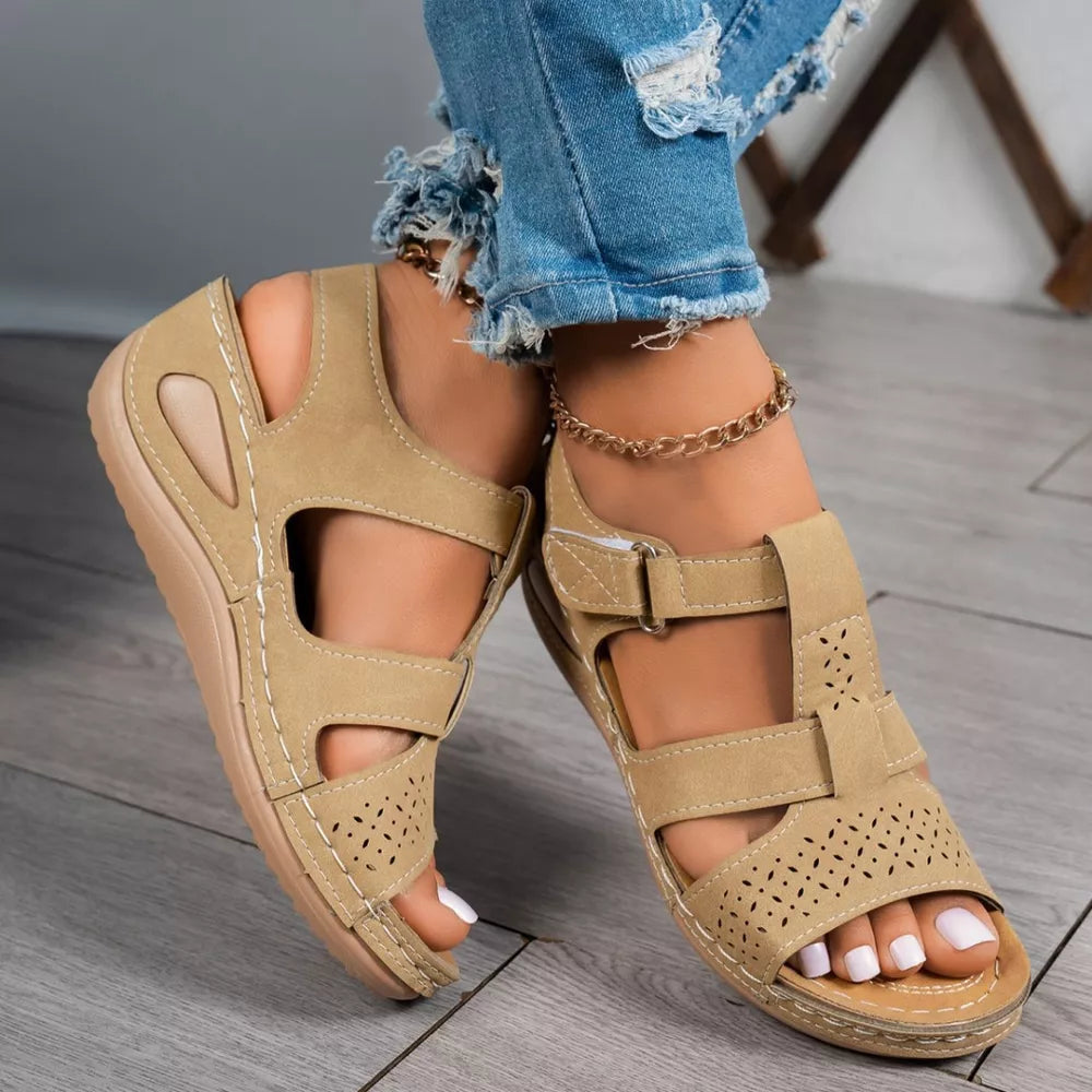 Brown perforated mid-wedge sandals with adjustable straps and breathable design.