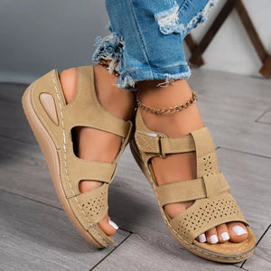 Brown perforated mid-wedge sandals with adjustable straps and breathable design.