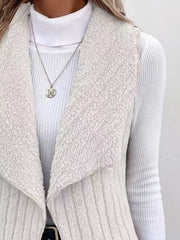Textured teddy collarless vest in white with a ribbed turtleneck and necklace.