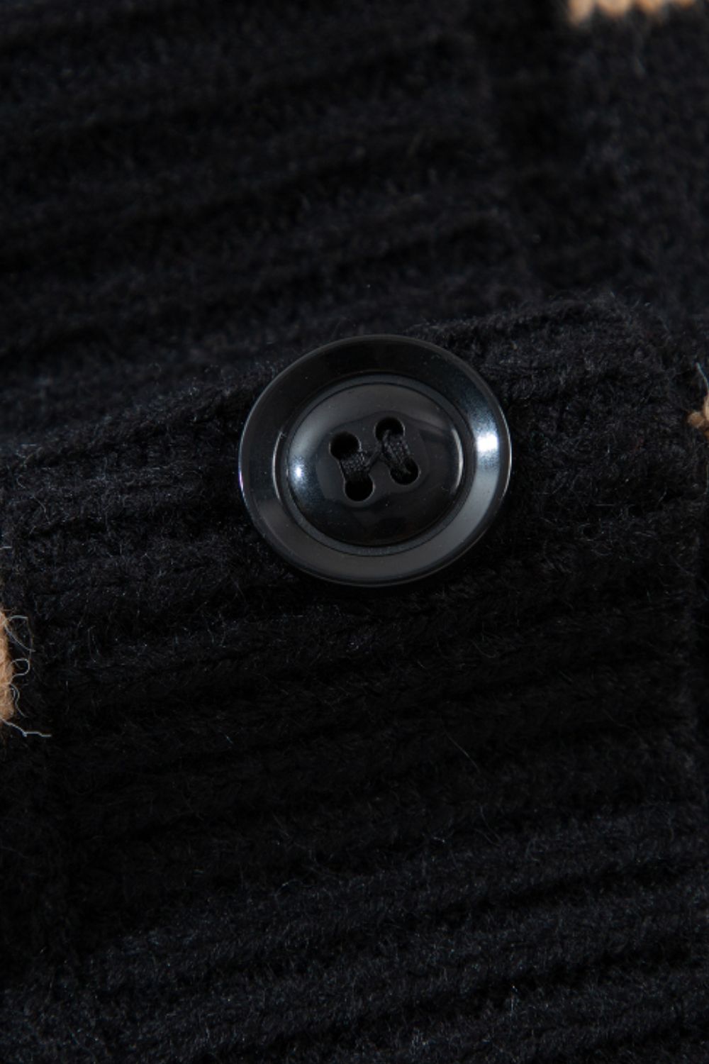 Black chunky knit button-down cardigan with a black button detail.