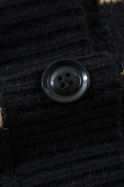 Black chunky knit button-down cardigan with a black button detail.