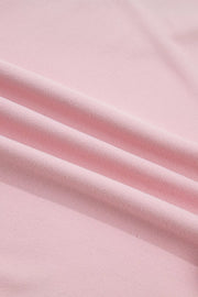 Pink maternity t-shirt with textured fabric and subtle pleats.