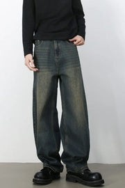 Faded baggy denim jeans in a distressed light blue wash with a relaxed fit.
