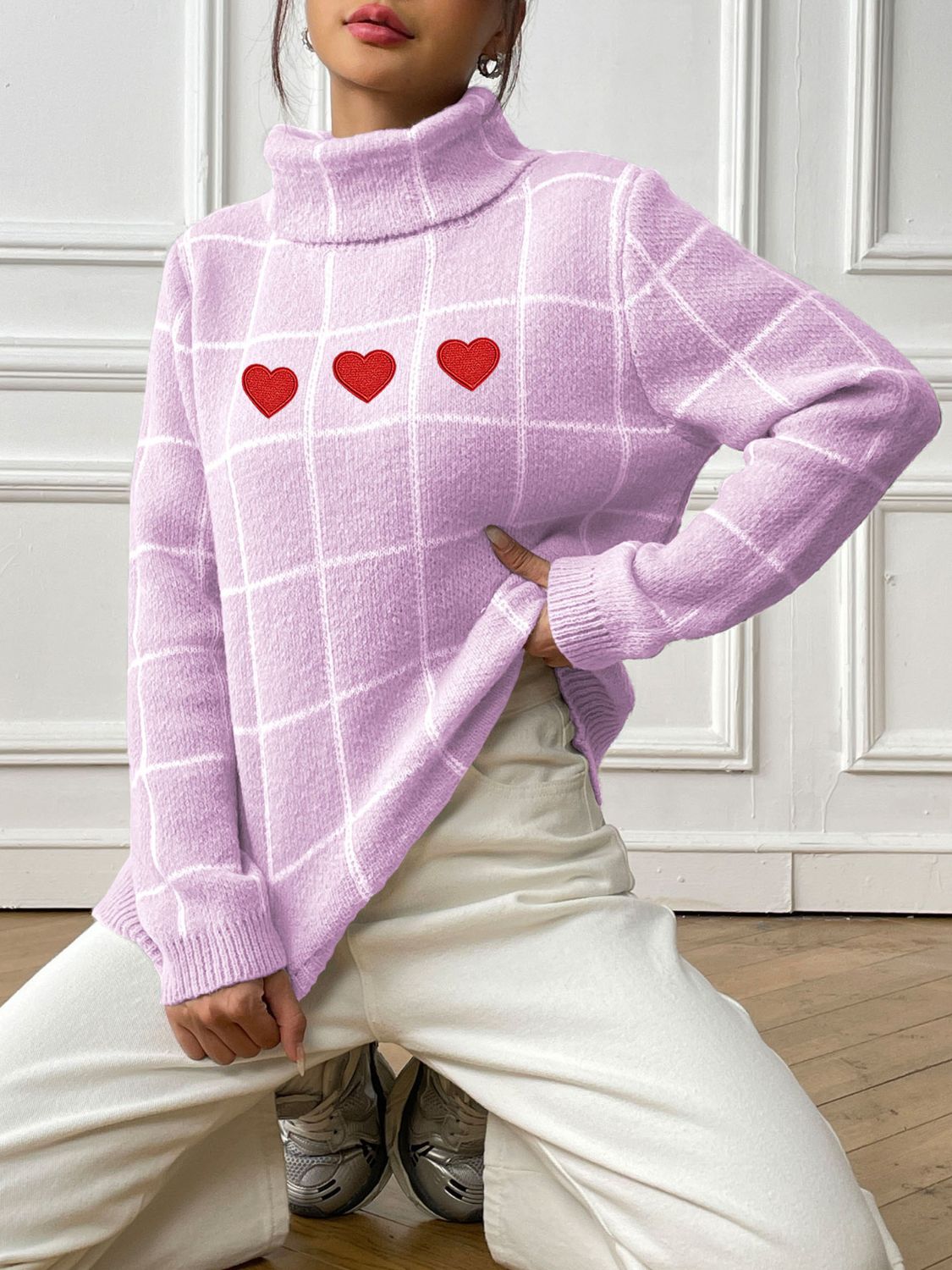 Pink purple gridwork turtleneck sweater with three red heart appliqués.