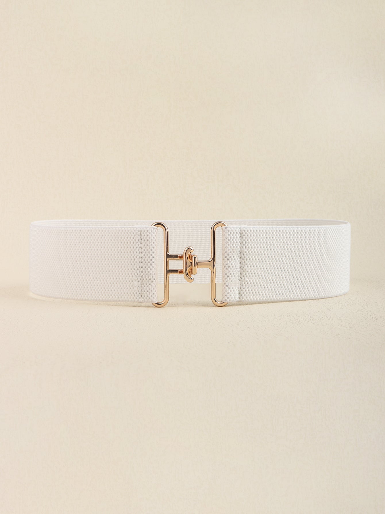 White elastic belt with sculpted gold buckle