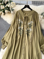 Khaki cotton maxi dress with embroidered floral detail and tie neck.
