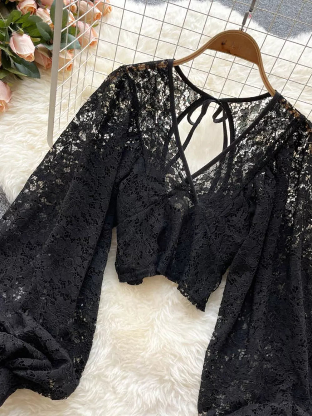 Black floral lace tie-back shirt with balloon sleeves and a cropped cut.