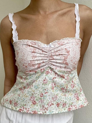 Mixed print corset cami with ruched bust, lace straps, and floral patterns in pink and pale blush.