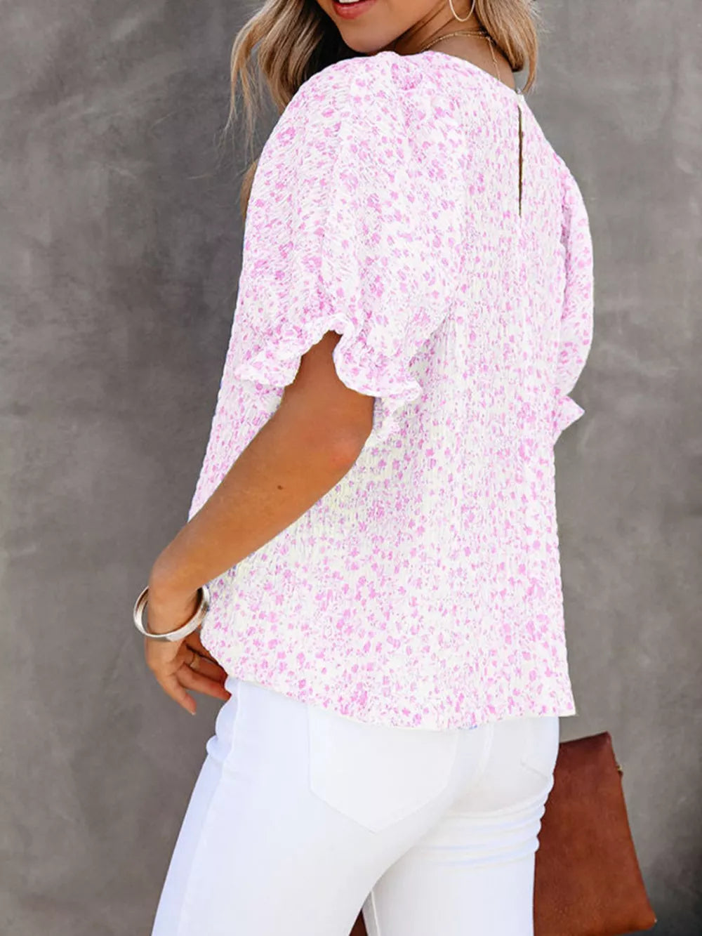 Pink floral print maternity blouse with smocked bodice and ruffle sleeves.