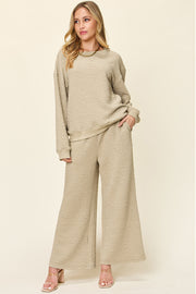 Textured lounge set in tan with crewneck sweatshirt and wide-leg pants.