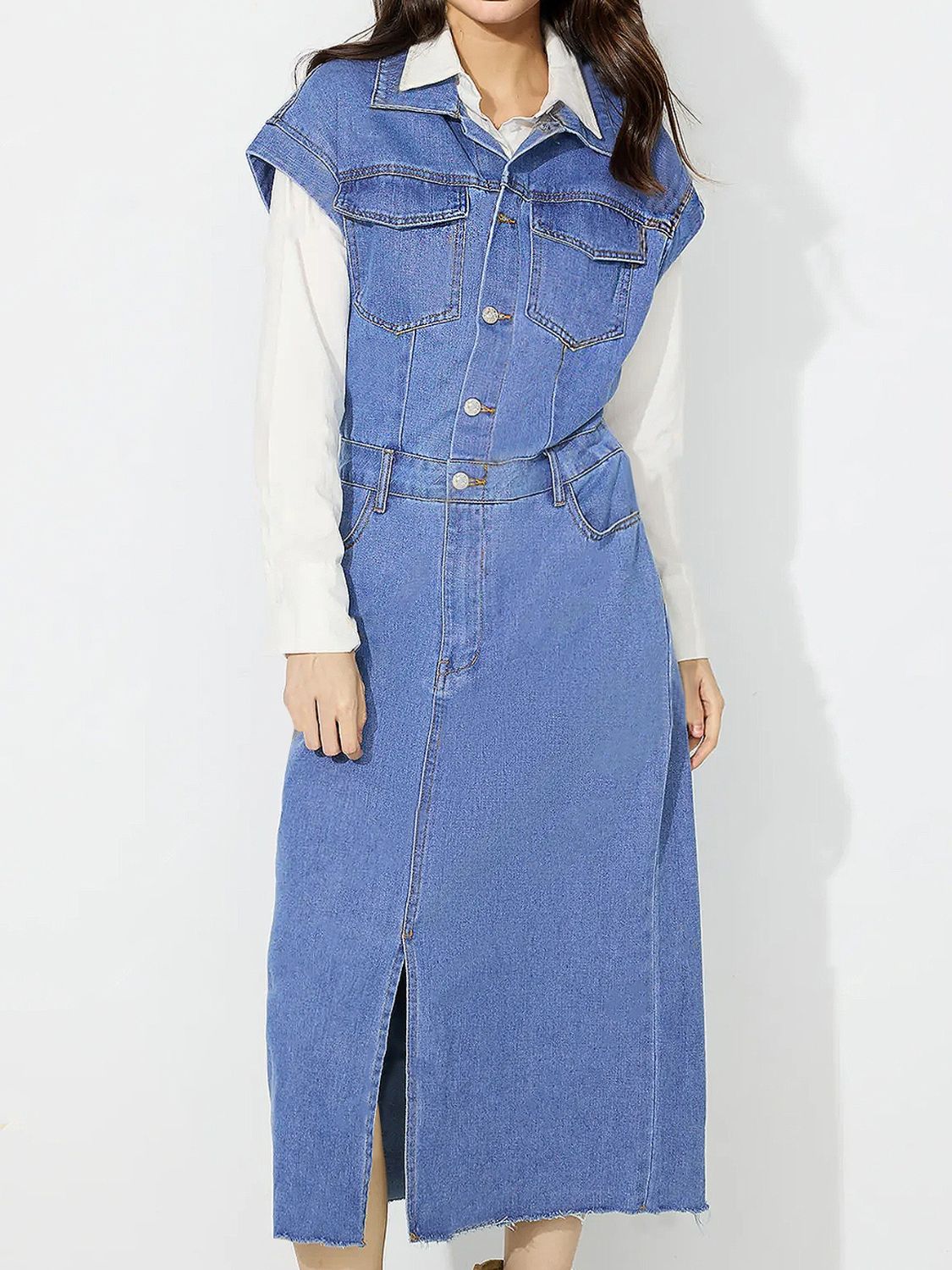 Sleeveless medium wash denim midi dress with button front, collar, and front slit.